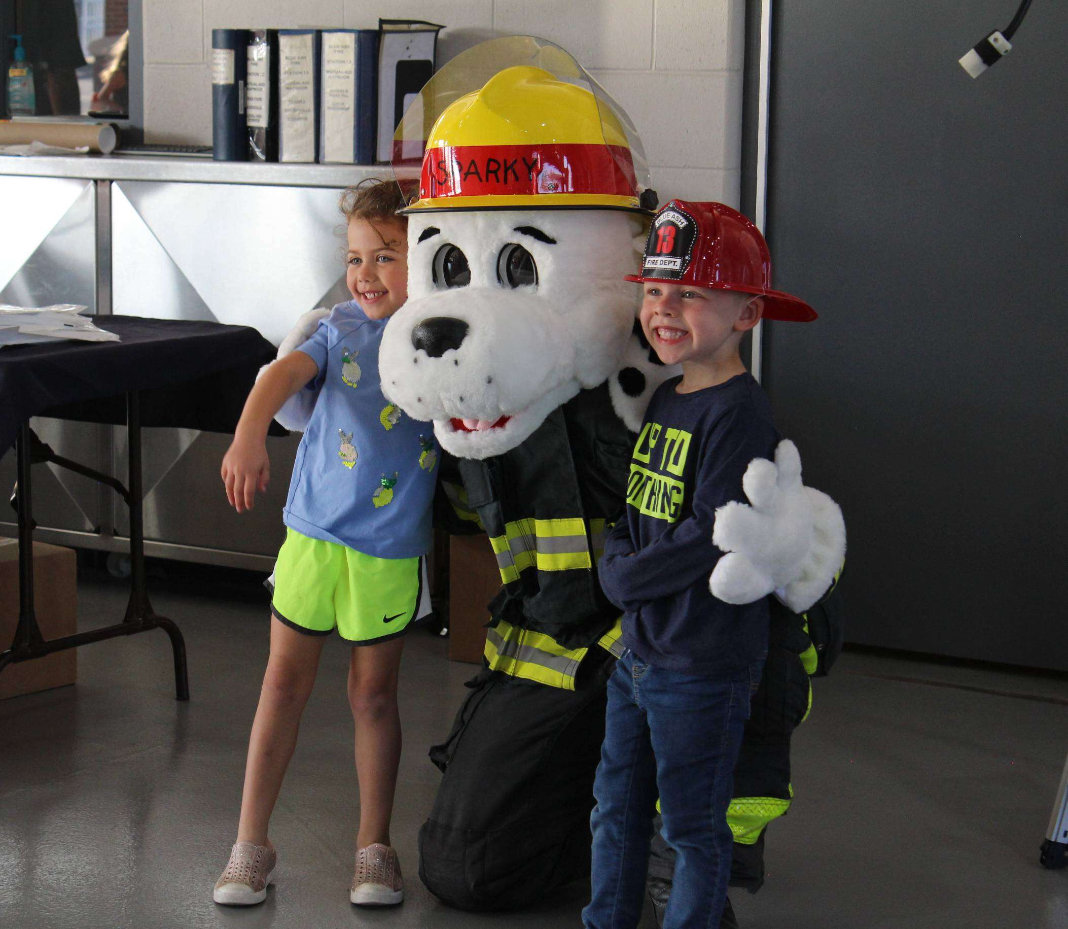 Sparky the fire dog mascot and two children